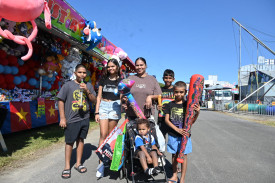 Kahyiem (left), Akallih, Kahlia, and Martin Canuto, Treshaun Person and baby Enemarki Zaro on the trolley from Manoora. PICTURES: Maddy Gavin