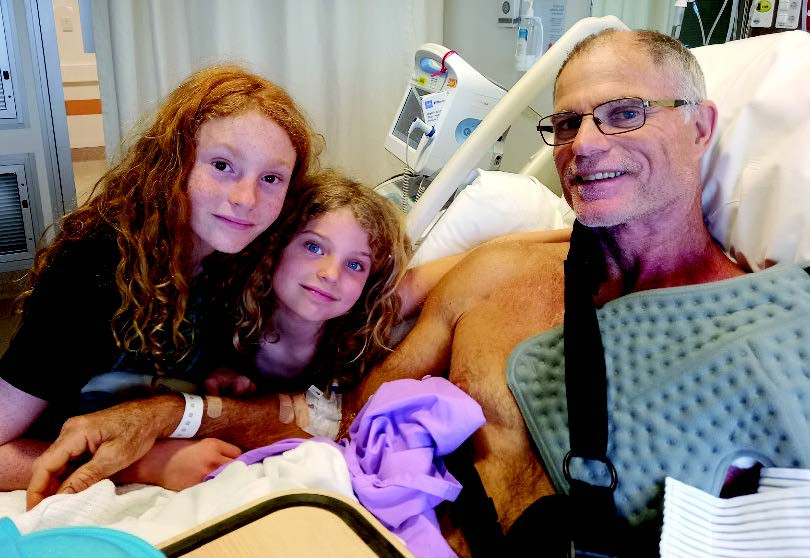 Marco in hospital recovering with his children Tristan (left) and Tiana.