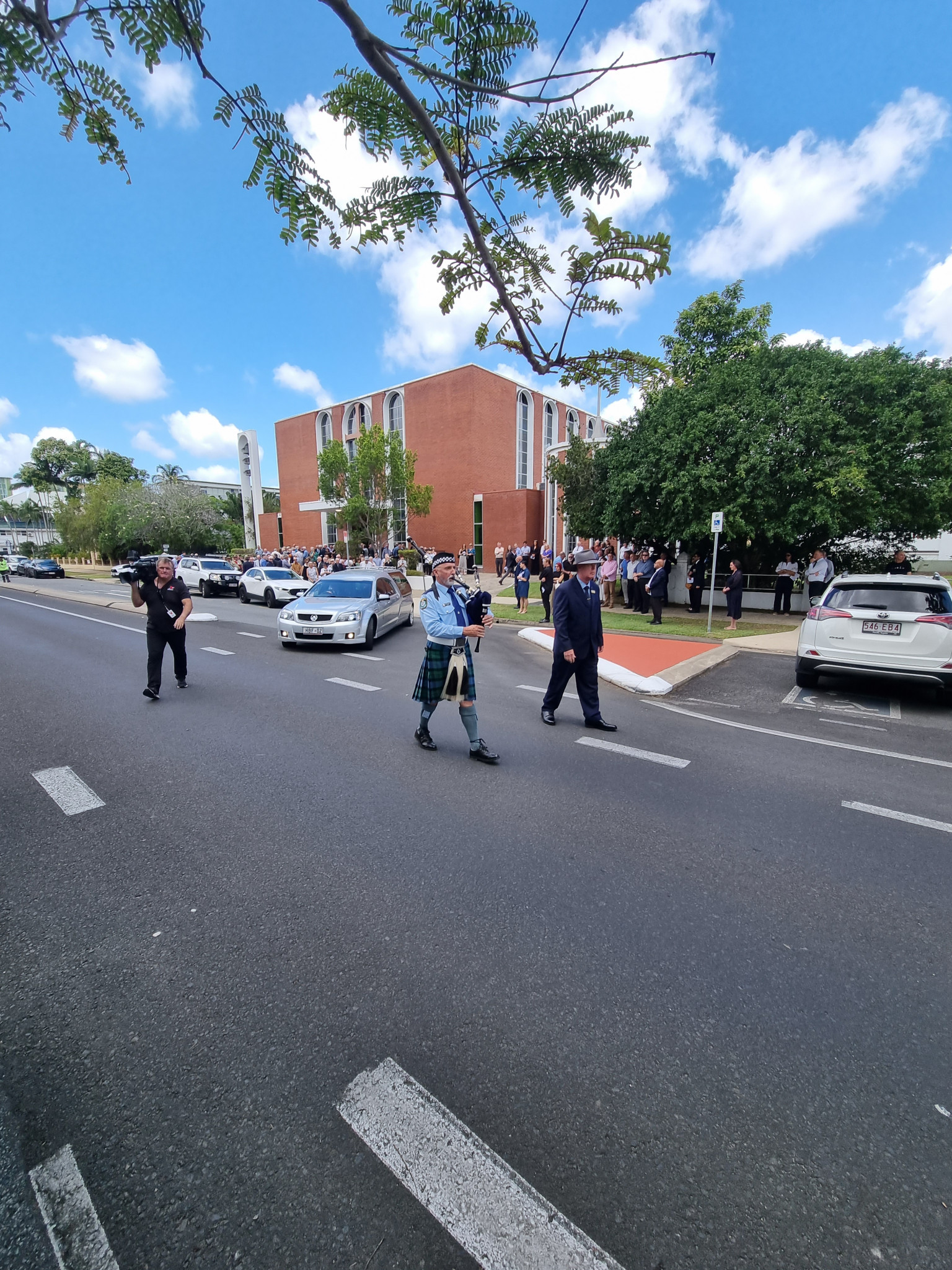 A bagpiper escorts the hearse carrying Kevin Byrne’s body to the cemetery.