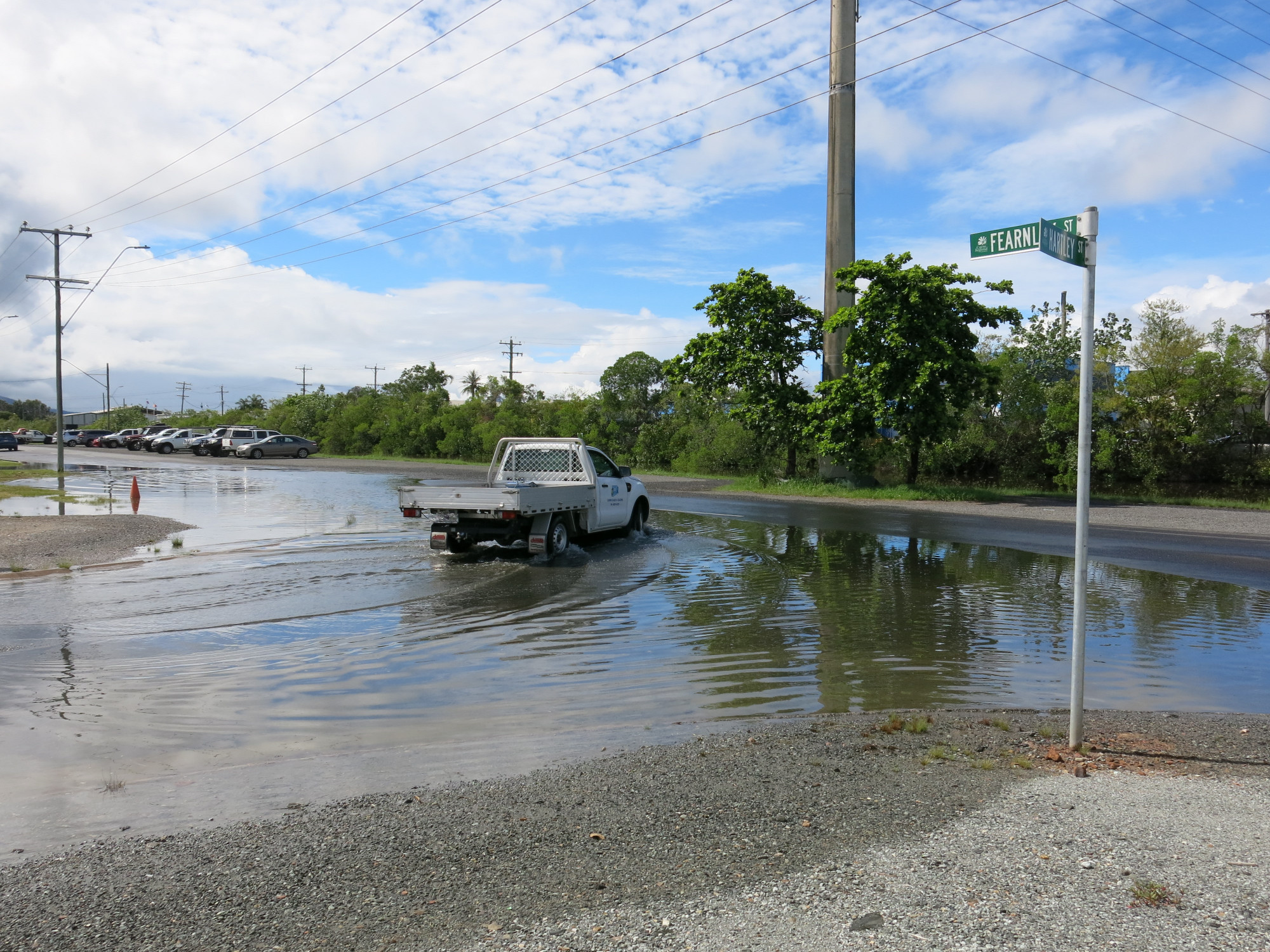 A vehicle drives through king tide floodwaters on Fearnley street in Portsmith. Motorists are reminded that tidal flooding is saltwater, which can damage cars on contact. PHOTO: Tanya Murphy