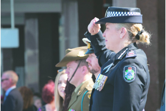 Commissioner Carroll salutes the passing officers in the NPRD parade in Brisbane, 2019.