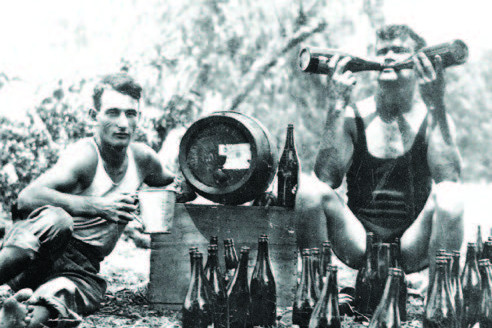 Jim Thompson (left) and Andy Mason (right) celebrating with bottles of home brewed beer at Cape Tribulation Sawmill. Cairns Historical Society Collection P23189