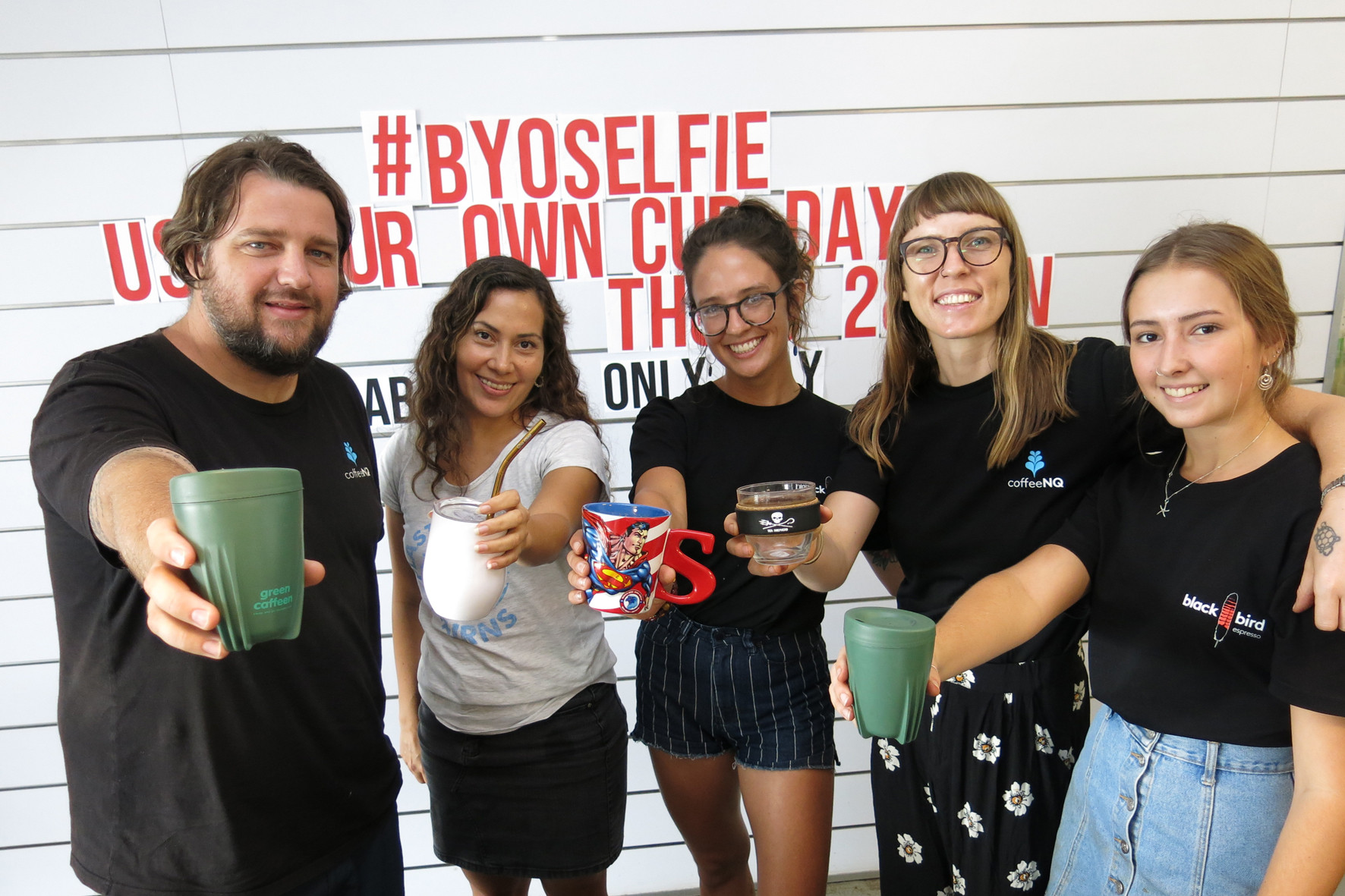 Blackbird Warehouse café founder Troy Furner, Plastic Free Cairns coordinator Helen Reilly, and staff show off some of the eco-friendly alternatives to single use disposable coffee cups. PHOTO: Tanya Murphy