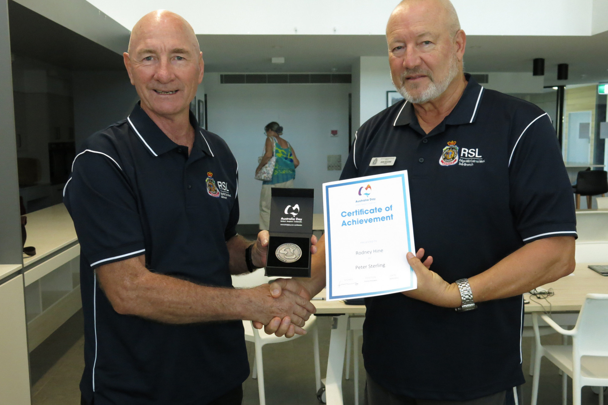 Rodney Hine (left) receives the Australia Day Medallion from Edge Hill / Cairns West RSL sub-branch president John Maschke.