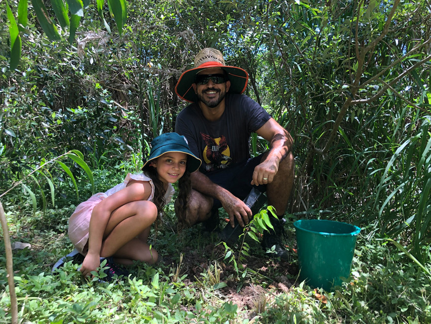 Israel Hajbi and daughter Arielle planting trees on Tu Bishvat.