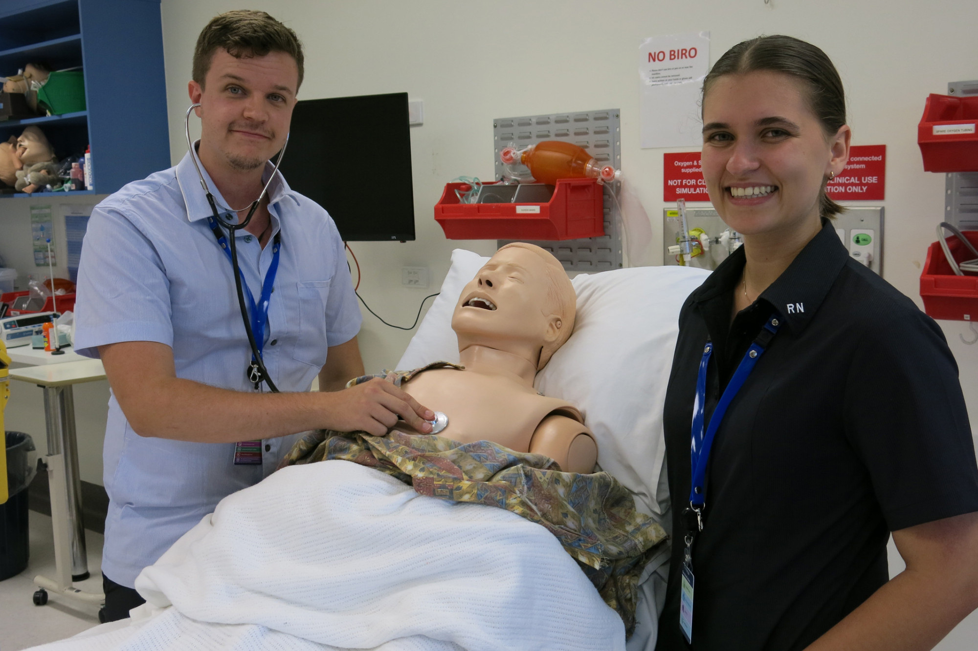 New registered nurses Michael Langguth and Miah Donnelly pretending to treat a patient at Cairns Hospital