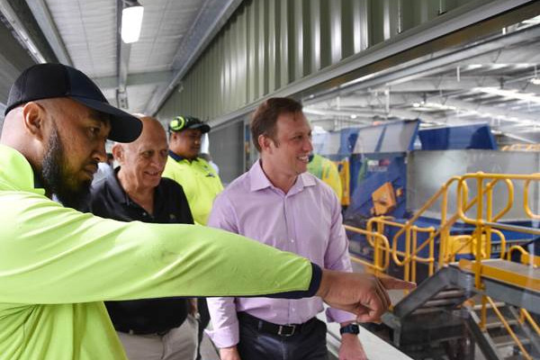 Council Resource Recovery Precinct leading hand Maru Saitu (left) showing Cairns Mayor Bob Manning (centre) and Deputy Premier and Minister for State Development Steven Miles around the new Materials Recovery Facility.