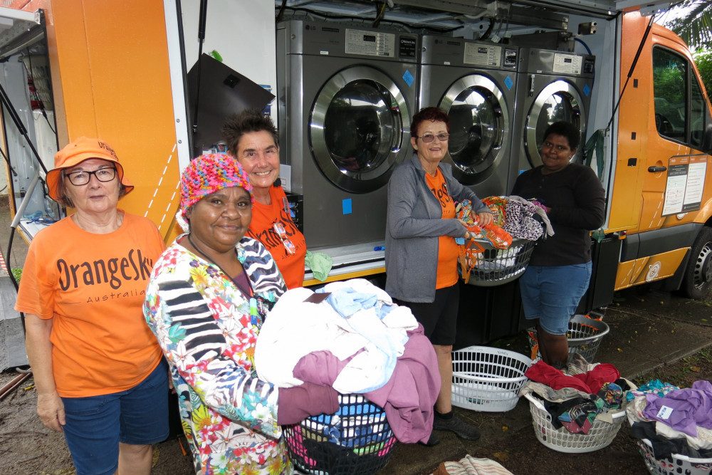 Valmay Wyles (second from left) and Delphine Getawan (right) put their laundry on with the help of volunteers Cathy Forbes, Lyndal Lowth and Yvonne Gordon