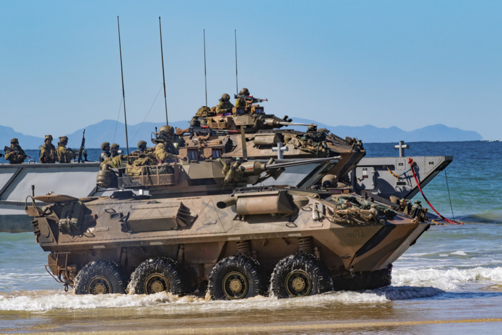 Australian Army soldiers with the 2nd Battalion, The Royal Australian Regiment aboard a light armored vehicle-25, come off a landing craft onto Langham Beach, Queensland, Australia, July16, during Exercise Talisman Sabre 2019. (U.S. Army Photo by Sgt. 1st Class Whitney C. Houston)