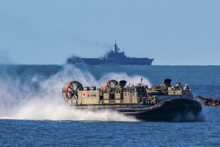 In front of the Japanese Ship Kunisaki, a landing craft, air cushion approaches Langham Beach, Queensland Australia, July 16, during Exercise Talisman Sabre 2019. (U.S. Army Photo by Sgt. 1st Class Whitney C. Houston)