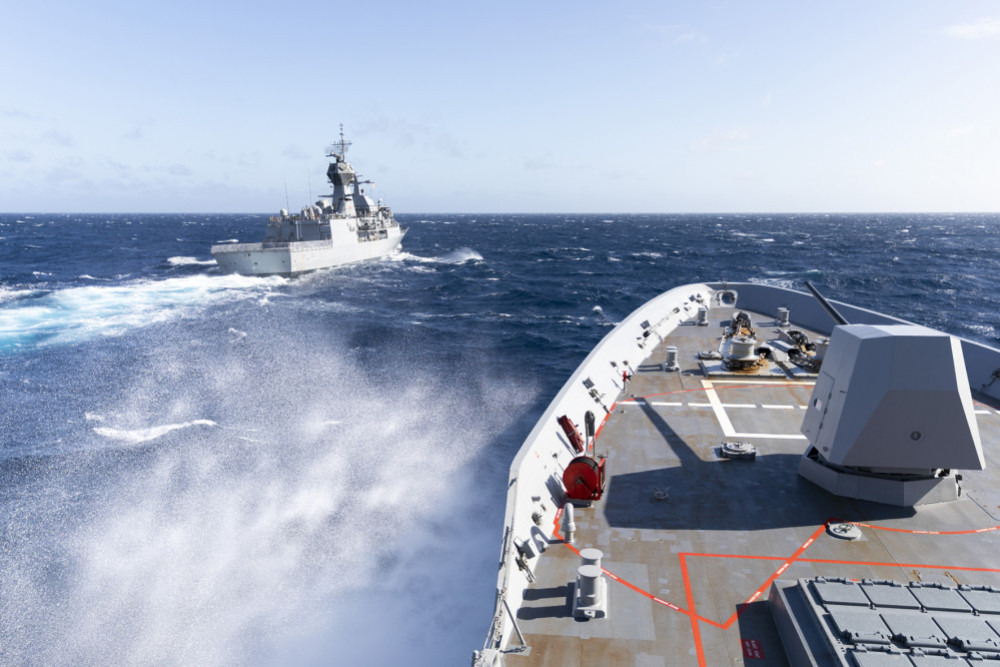 HMAS Brisbane sails alongside HMAS Parramatta during replenishment at sea approach, off the coast of Queensland, during Exercise Talisman Sabre 2021.