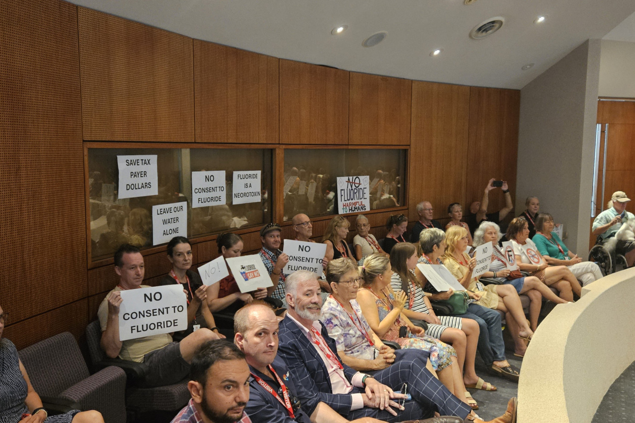 Anti-fluoride protestors waved placards during today's rowdy council meeting. Picture: Nick Dalton