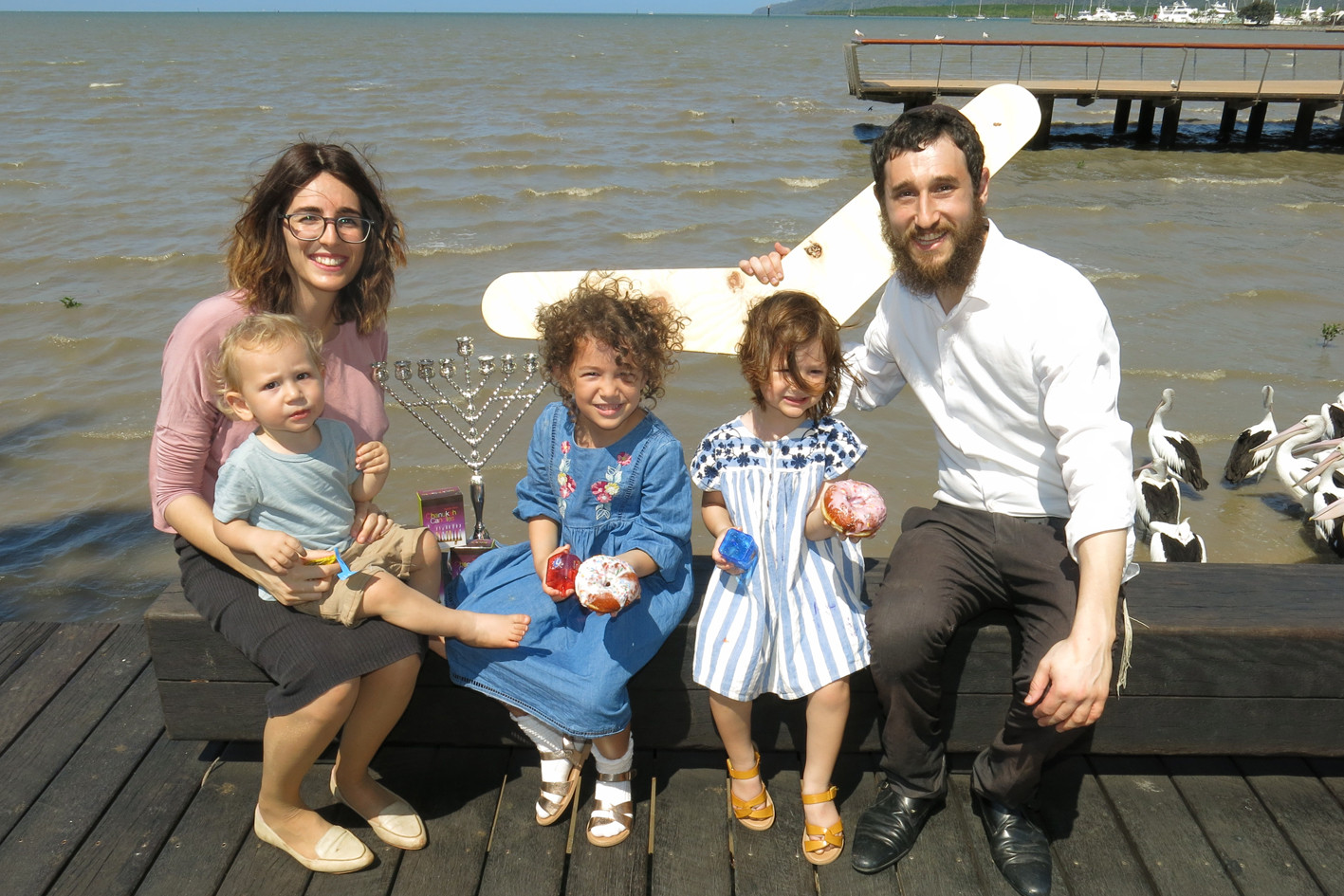 Rabbi Ari Rubin (right) and wife Mushkie Rubin with their children Shlomo, Dellie and Adina are excited to celebrate Hanukkah with festive traditions such as eating oily foods like donuts, giving out gelt (chocolate coins), and playing with a dreidel (a spinning toy). PHOTO: Tanya Murphy