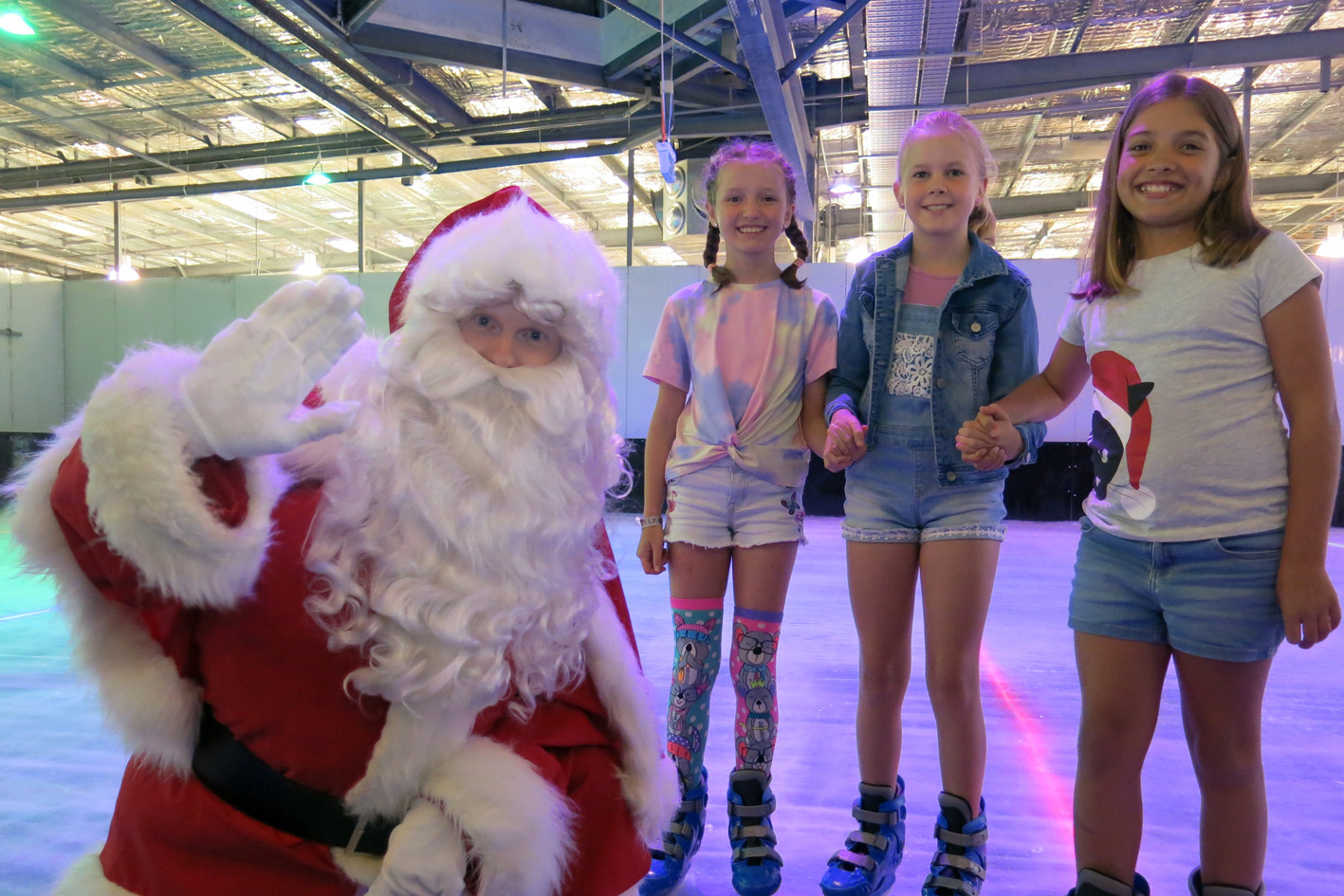 Santa with Ruby Abel (10), Angelica Picco (10) and Caitlin Chenoweth (9). Photo by Tanya Murphy