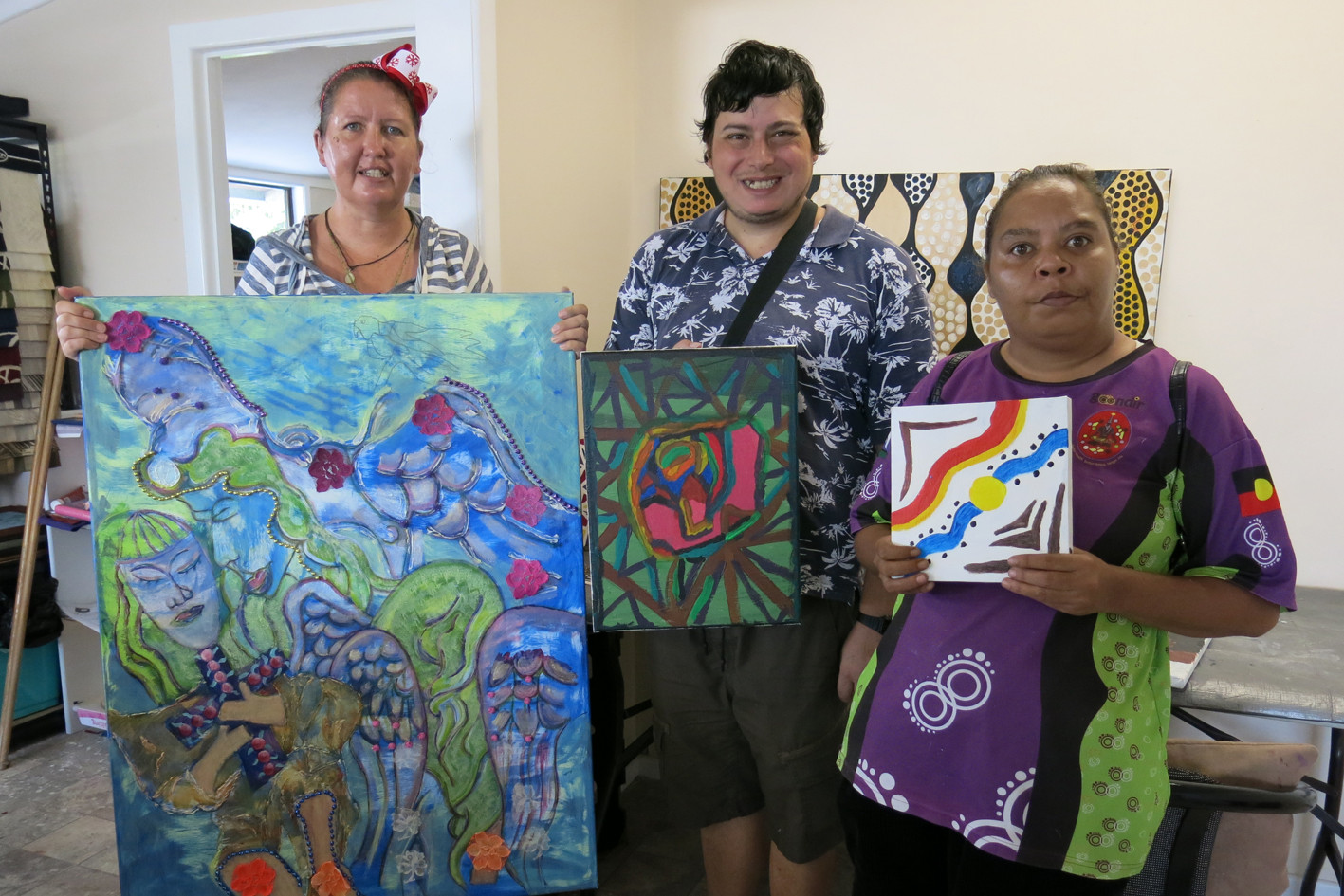 Junction Clubhouse members Sarah-Jane Deron, Matthew Scicluna and Cynthia Yeatman show off paintings they produced at the clubhouse.