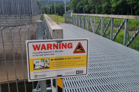 Signs have just gone up near a drain feeding Saltwater Creek behind Piccone’s shopping centre at Manoora warning about a crocodile. Photo credit: Nick Dalton