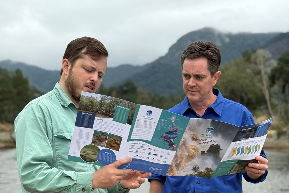 Wet Tropics Waterways executive officer James Donaldson (left) and chairman Simon Costanzo read through the 2025 report card. Picture: Wet Tropics Waterways.