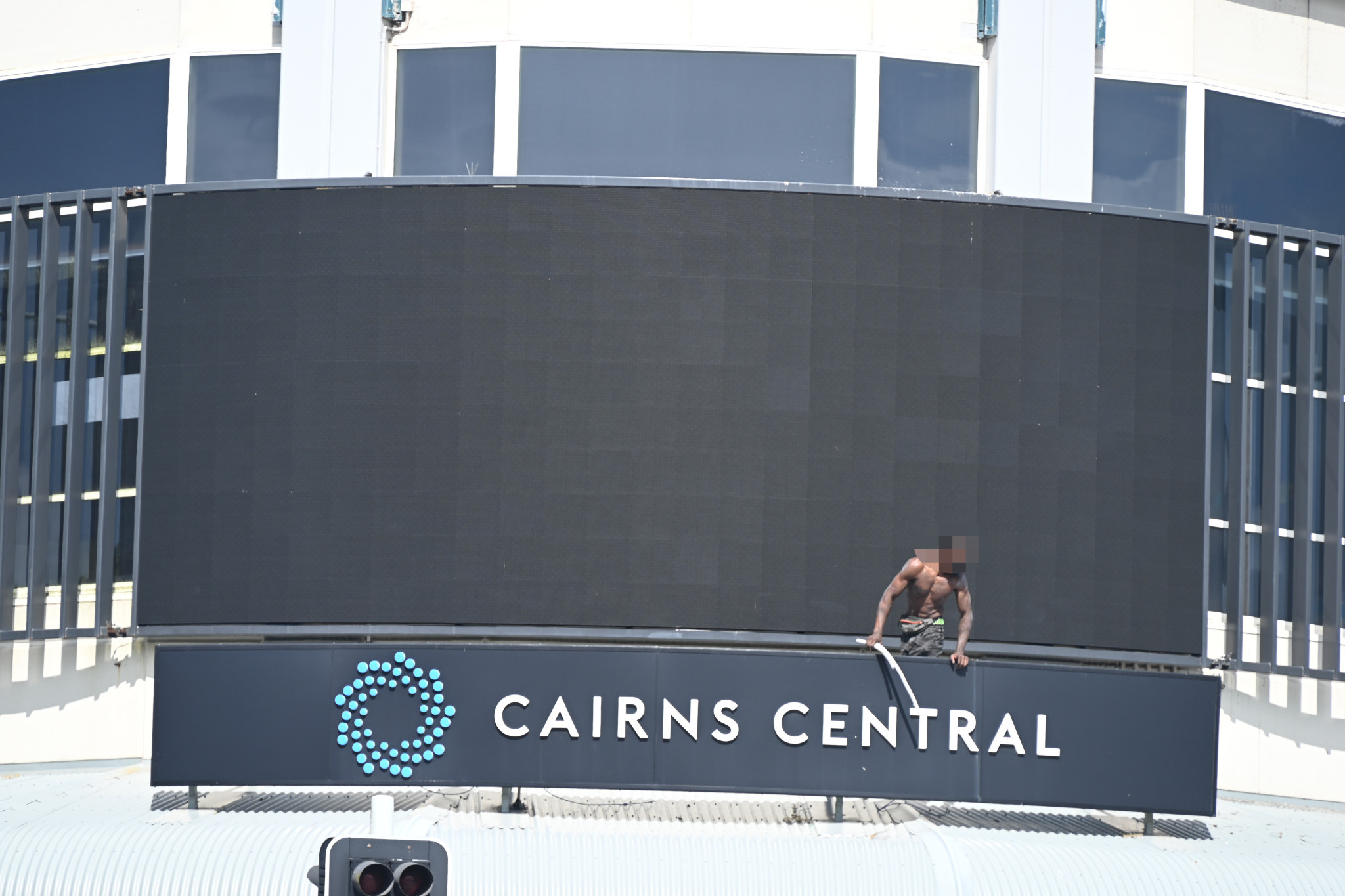 The man who climbed onto the roof of the Cairns Central shopping centre has finally gotten down. Picture: Isabella Guzman Gonzalez