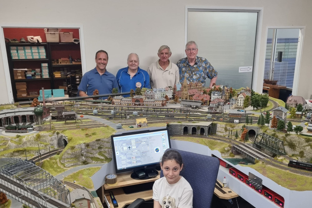 Ashlynne Musumeci, 11, at the controls of the club’s showpiece train set and at the rear (from left) Steve Mortimer, John King, Ian MacLeod-Carey and Ken Dixon. Picture: Nick Dalton