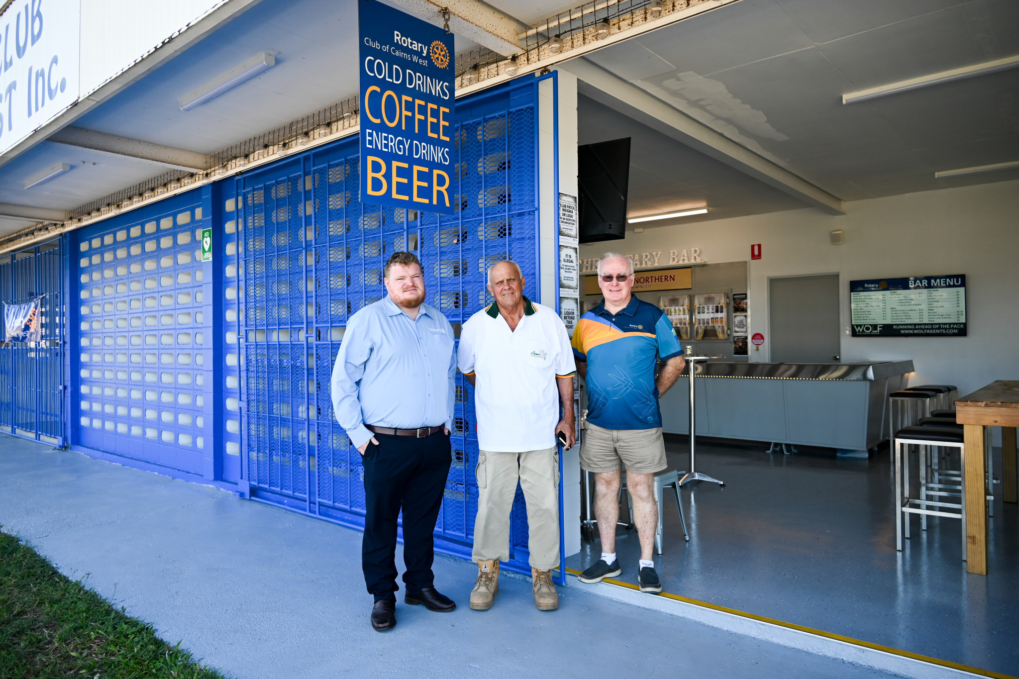 Sam Dyer, Ian Allen, and Col Craig stand in front of the Rotary Bar’s bold new exterior, painted in Rotary Royal Blue - the official colour of Rotary International. Picture: Lizzie Vigar