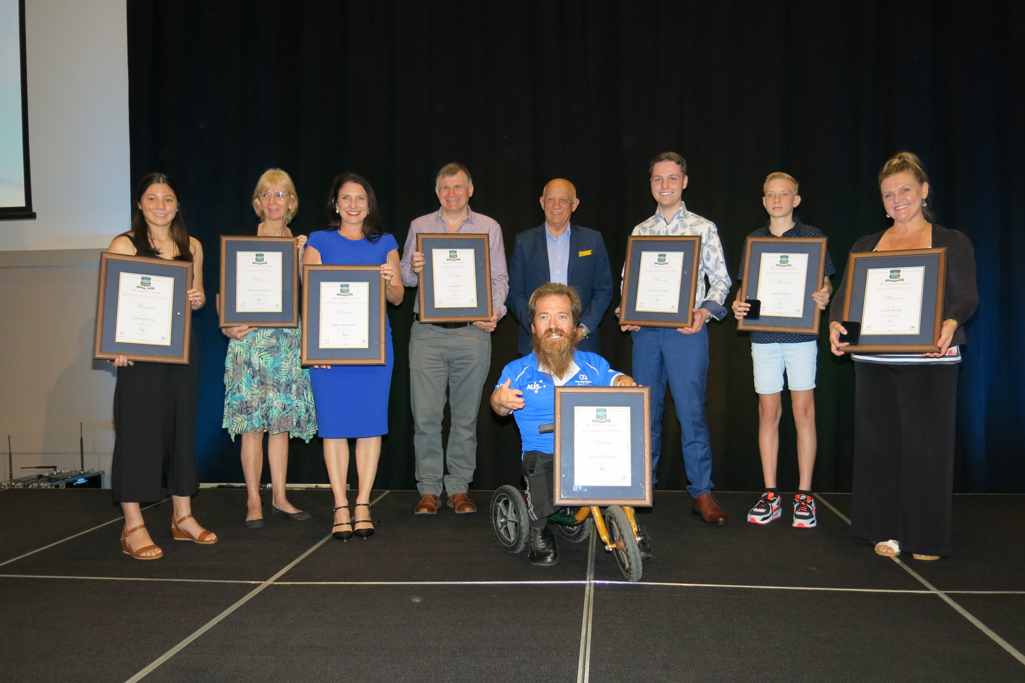 Mayor Bob Manning (back centre) with Australia Day Award recipients (from left) Ashleigh Ung, Glynnis Kiernan, Janine Bowmaker, Ian Roberts, Grant “Scooter” Patterson, Harrison Oates, Caleb Nissen, and Rachel Bradley (on behalf of Terry Doyle). Photo by Tanya Murphy.