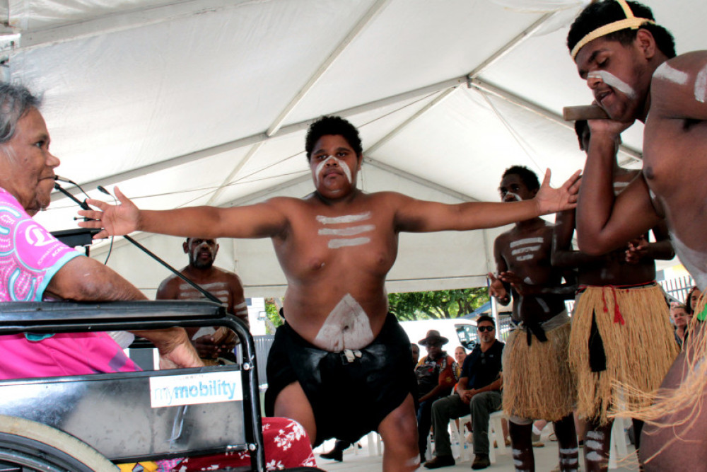Buri Guman (One Fire) dancers Leroy Yeatman and Jerome Stafford-Hill (right) dance for Aunty Fiona Patterson (in the wheelchair) at the opening of the new Gurriny Yealamucka Health Services Aboriginal Corporation’s new building on Workshop St, Yarrabah. Photo by Christine Howes.
