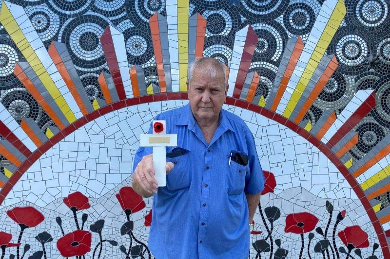 Mossman RSL Secretary Wally Gray helped assemble the crosses, placed a red poppy on each and dipped them in protective coating.