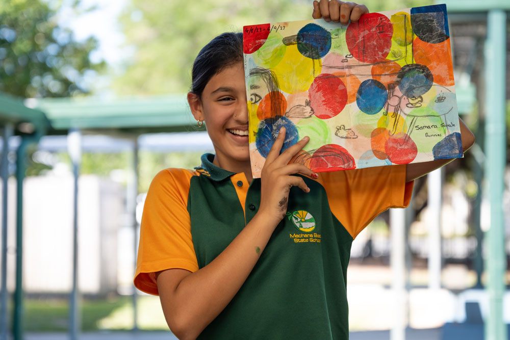 One of the 25 Machans Beach State School students, Samara Sewak, with her self-portrait, Bunnies, which features in an exhibition at Tanks Arts Centre. Picture: Emily Barker of FNQ Roar Media & Photography