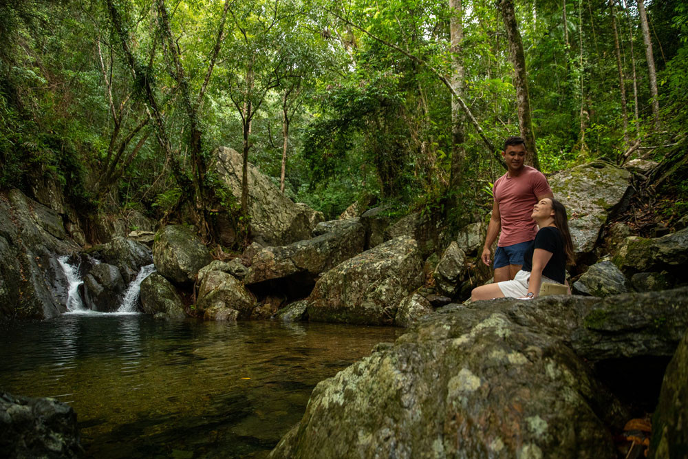 A visiting couple enjoy the tranquility of Stoney Creek, Kamerunga. Tourism Tropical North Queensland says the region’s natural surroundings are attracting more tourists. Picture: Tourism Tropical North Queensland