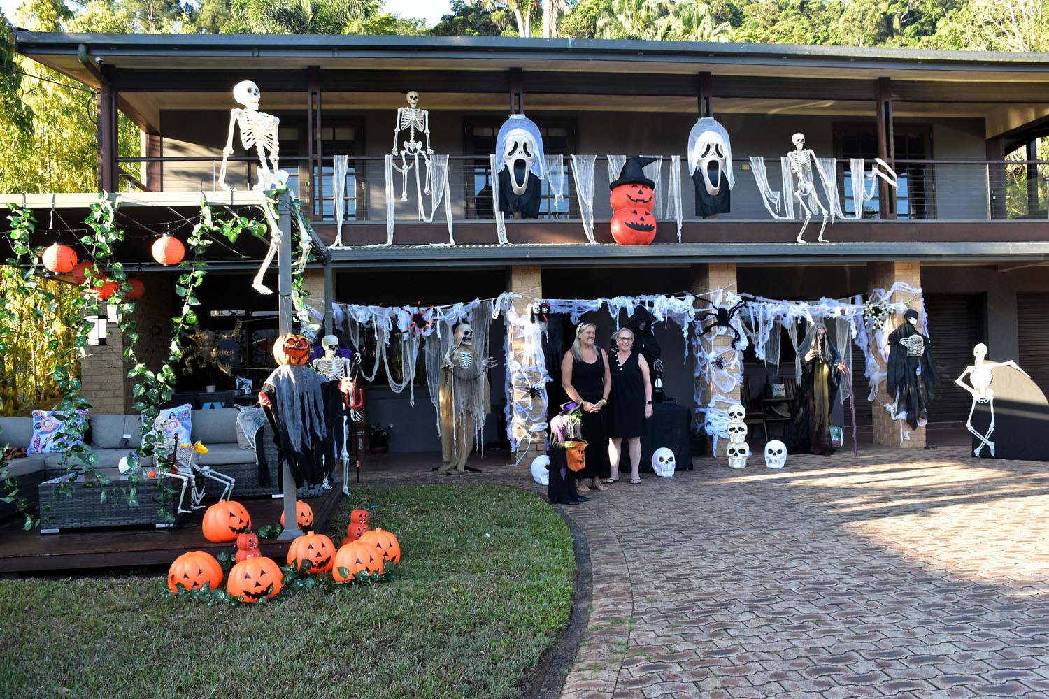 Melissa Raco (left) with her friend Michelle (surname withheld) standing in front of her spook-tacular Halloween display at the end of Hutchinson Street, Edge Hill. Picture: Hugh Bohane