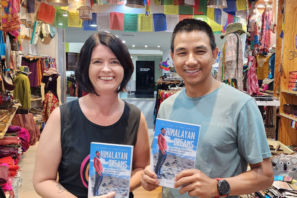 Author Kirsty Nancarrow and Som Tamang with the book she wrote about him called Himalayan Dreams: The Story of Som Tamang. It is being launched in Cairns next month. Picture: Supplied