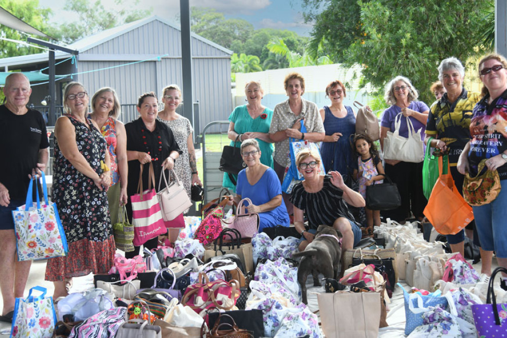 Handbag Project founder Trudy Tschui (centre) with volunteers and dozens of bags for victims of domestic violence. Picture: Supplied