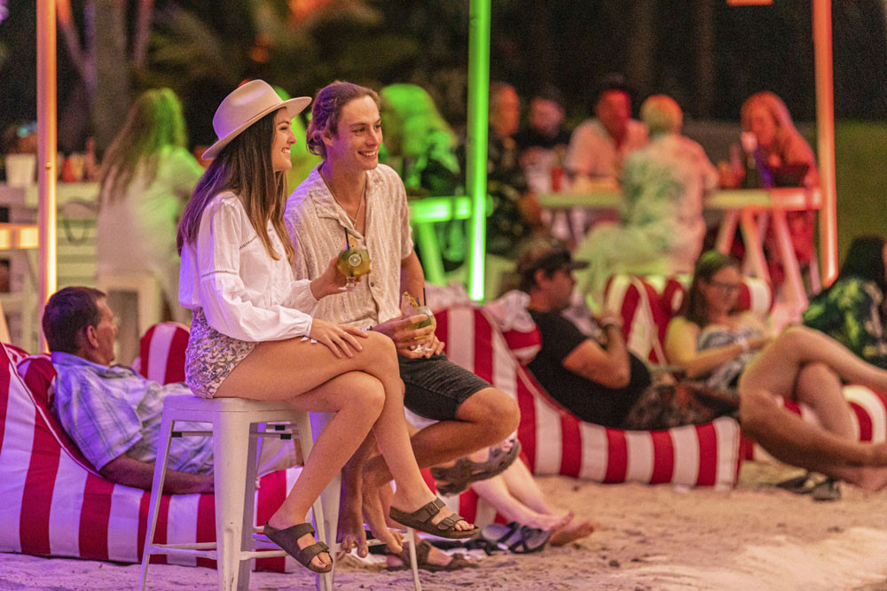 A couple enjoy the Sheraton Cafe del Mar’s Sunset Sessions which are part of Port Douglas Carnivale later this month.