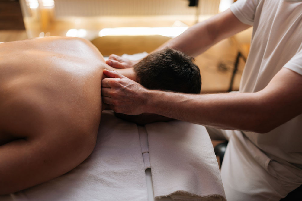 A physiotherapist works to relieve a patient’s headache.