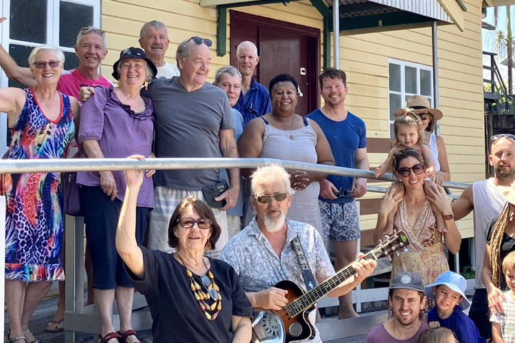 Locals, Machans Beach Community Association members and Machans Beach folk duo Wind and Wood (centre) Morag and Trevor Gane. Picture: Supplied