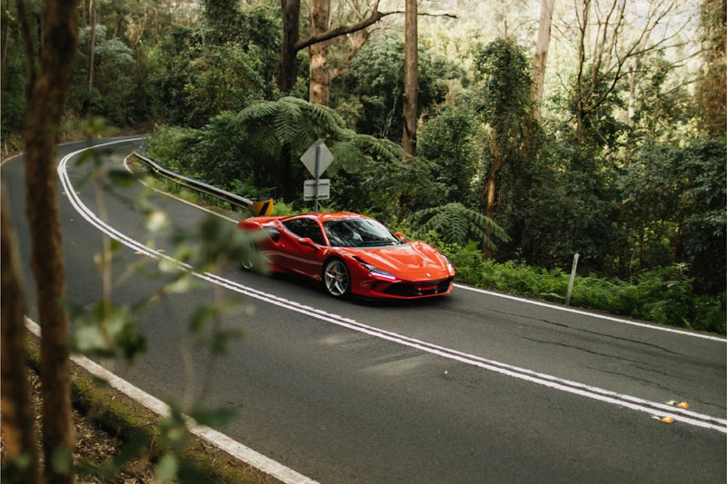A Ferrari 296 GTB is one of several supercars available as a special luxury driving experience at The Reef House Adults Retreat.