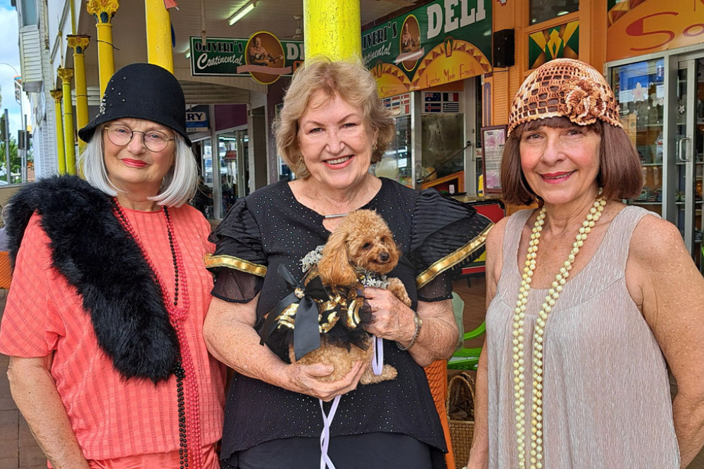 Val McCallum (left), Innisfail and District Historical Society president Trish Ernst with her deco doggy and Diane Vitale, dressed to impress in their art deco style. Picture: Supplied