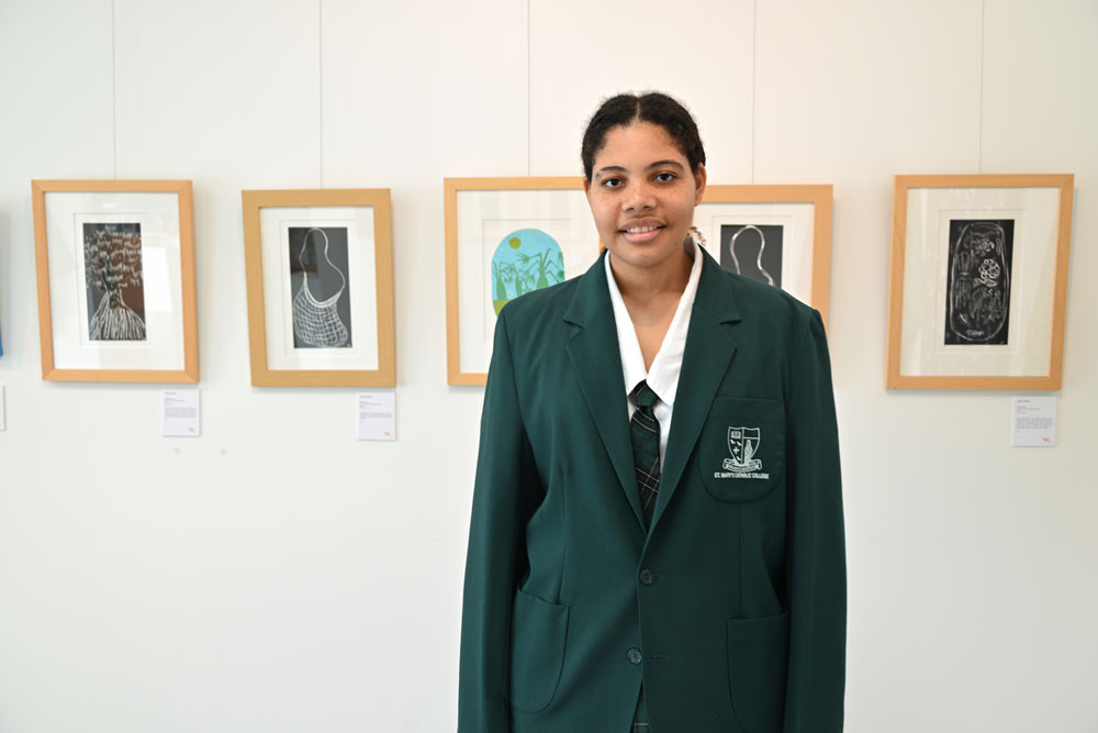 Jahzara Michl with her lino prints at UMI Arts ‘Culture Through Our Eyes’ exhibition at Manoora. Picture: Isabella Guzman Gonzalez