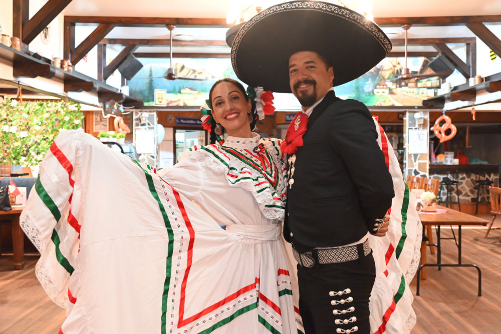 Latin Roots dancer Carolina Contreras (left) and event organiser Jose Uriel Navarro invite people to the Dia de Muertos celebration at the German Club. Picture: Isabella Guzman Gonzalez