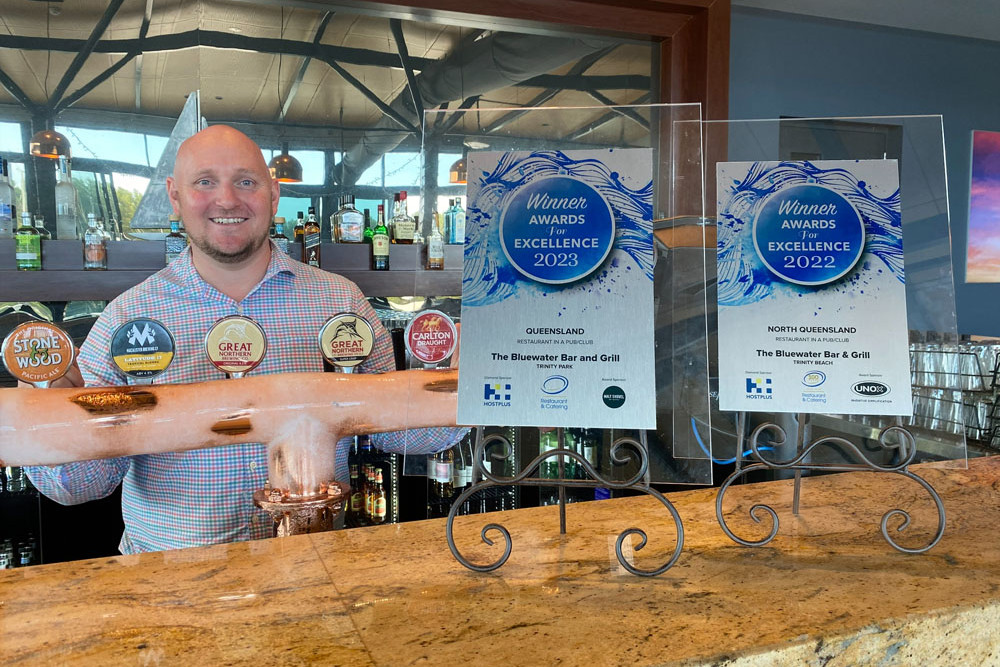 The Bluewater owner Alex Sayers with the two best restaurant in pub or club bar awards. Picture: Supplied