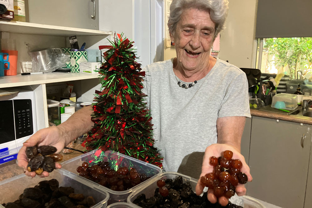 Jane Johnston, who bakes Christmas puddings and cakes, with her dried fruit supply ahead of a busy festive season.