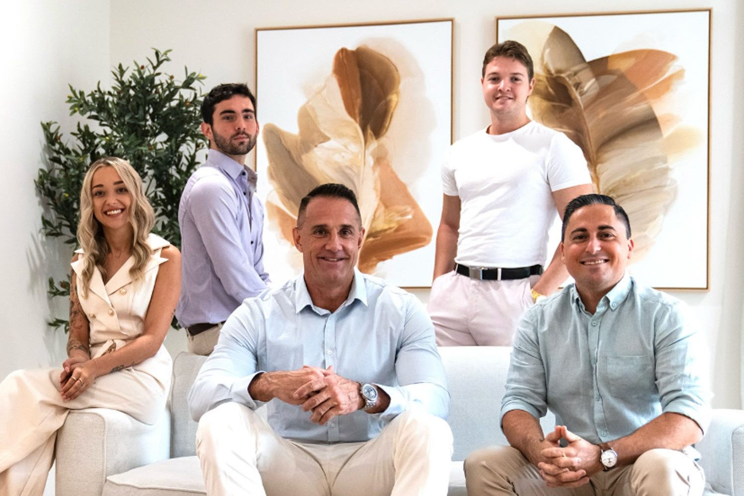 Troy McGuane (centre) with the Palm House Property team. Picture: Supplied