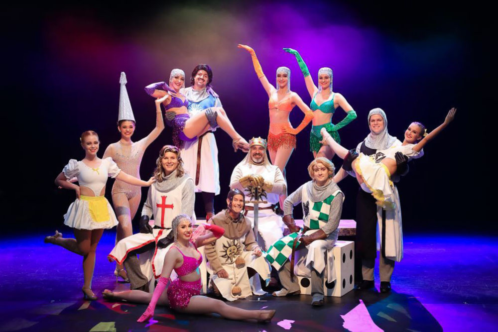 Knights (L-R): Chris George (Sir Galahad), behind John Margetts (Sir Bedevere), sitting Michael Newman (King Arthur), Kieran Walsh (Sir Robin), in front kneeling - Shawn Brack (Patsy); and Dancers (L-R) Sienna Beh, Keely MacKenzie, Olivia Dorries, Lara Spooner, Jaimee Chill, Ava-Louise Bowes (carried), and front, Lara Barnes.
