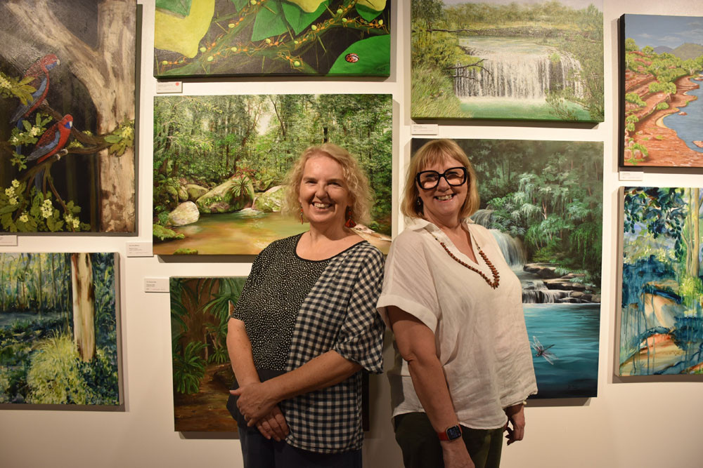 Cairns Arts Society secretary Joanne Bingham (left) and president Lorna Epps at the society’s latest exhibition. Picture: Isabella Guzman Gonzalez