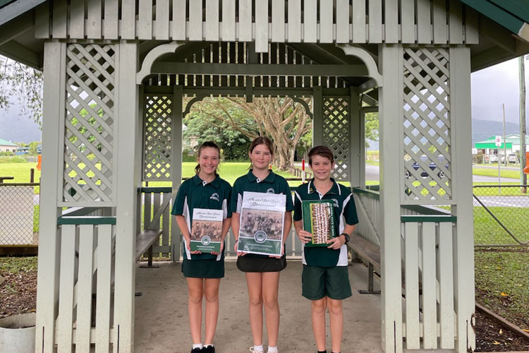 Aloomba State School Students Matilda Henderson (left), Lael Coleing and Heath Schweitzer with the 125th anniversary book. Picture: Supplied