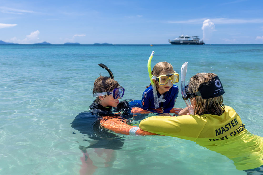 Children enjoy a snorkelling tour with a reef master guide as part of a Frankland Islands Reef Cruises express tour. Picture: Entrada Travel Group
