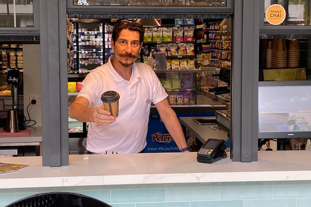 Veivers Cafe barista Alessandro (surname withheld) serves a takeaway coffee. Picture: Supplied