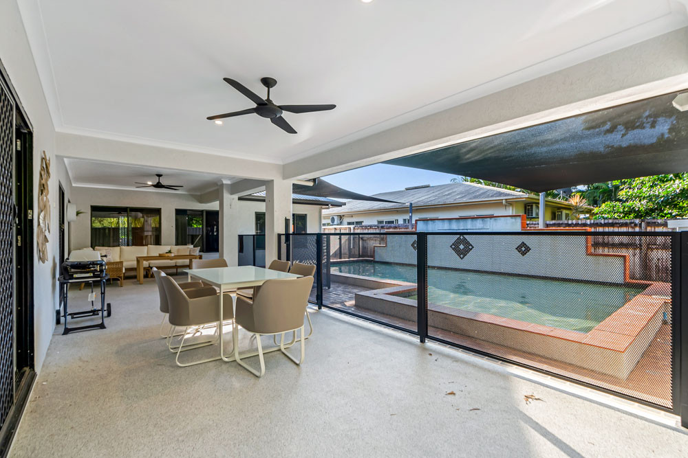 A large freeform pool with a waterfall takes centre stage at this Corella St home at Craiglie. Pictures: Supplied