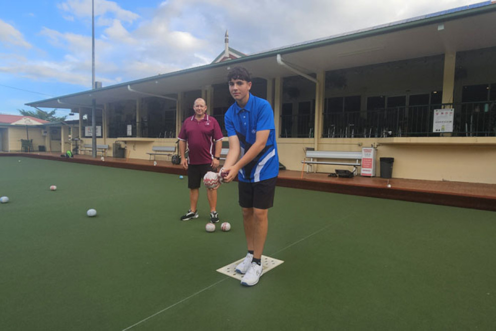 Bowls Queensland chief executive Brett Wilkie (left) gives some coaching tips to promising teenager Rhys Gillman. Pictures: Nick Dalton