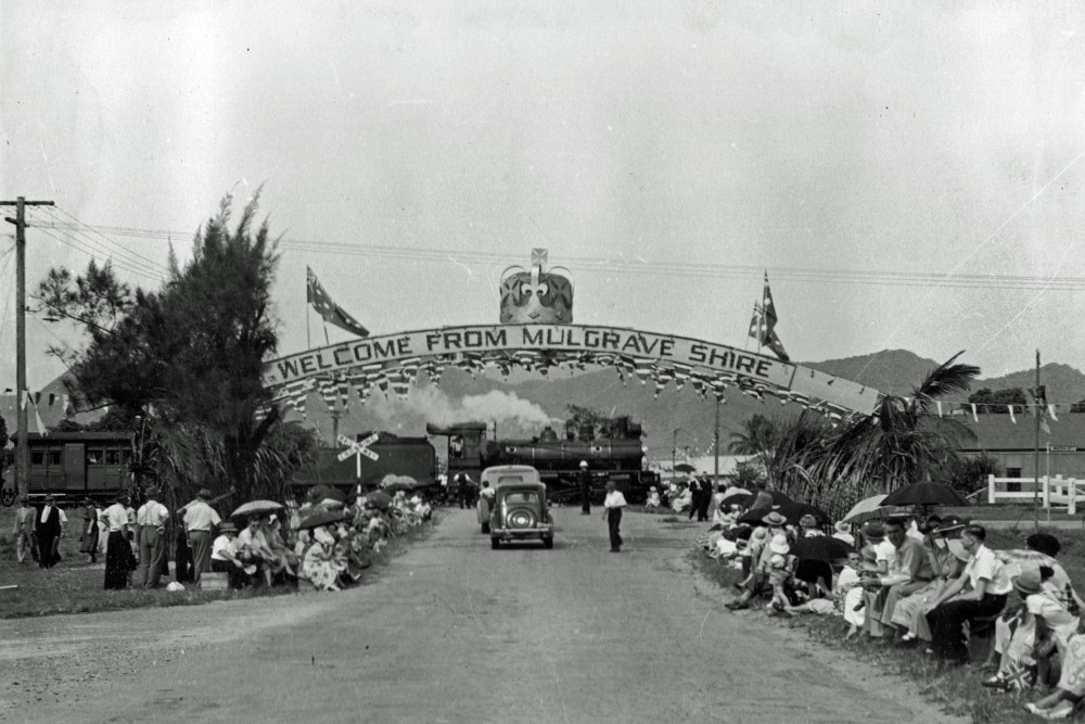 Flanked by onlookers awaiting the Royal procession, the Mulgrave Shire Arch was resplendent with a giant crown, flags and bunting. Photograph courtesy MSHS.